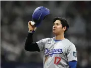  ?? LEE JIN-MAN — THE ASSOCIATED PRESS ?? Dodgers designated hitter Shohei Ohtani takes his helmet off after hitting an RBI single during the eighth inning of an opening day game against the Padres at the Gocheok Sky Dome in Seoul, South Korea on Wednesday.