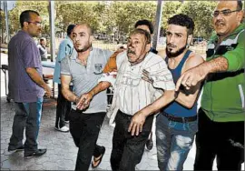  ?? GEORGE OURFALIAN/GETTY-AFP ?? An injured Syrian gets assistance outside a hospital following shelling Friday on a government-held neighborho­od in the northern Syrian city of Aleppo.