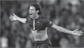  ?? — AFP ?? Paris Saint- Germain’s Edinson Cavani celebrates after scoring against Saint- Etienne during their French Ligue 1 match at the Parc des Princes Stadium in Paris on Sunday. PSG won 5- 0.