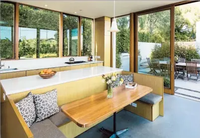  ?? Photog raphs by Ricardo DeAratanha Los Angeles Times ?? THE KITCHEN AND BARBECUE AREAS f low together with the use of glass doors and window in the home of David Golubchik and Rina Welles. The modern wing by Dub Studios connects to the original house, once Bertolt Brecht’s home.