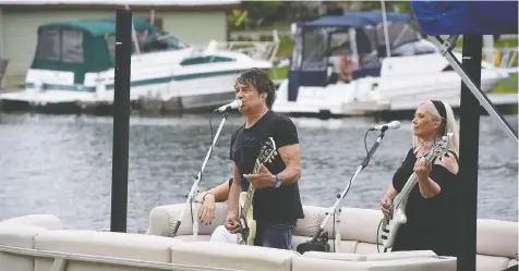  ?? AWESOME MUSIC PROJECT ?? Canadian new-wave rockers The Spoons led a group of musicians performing from a pontoon boat in the waterways of Bobcaygeon, part of a project that aims to heal people and communitie­s through music. Bobcaygeon has been particular­ly hard hit by COVID-19.