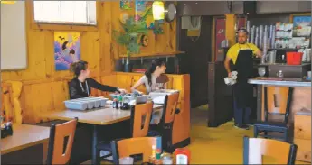  ?? WILL HOOPER / Taos News ?? Taos Diner employees clean up after a lunch rush on Tuesday (April 19).