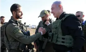  ?? EyePress News/Shuttersto­ck ?? Benjamin Netanyahu, right, greeting soldiers at the Gaza border last week. Photograph: