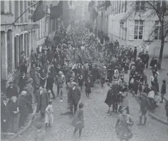  ??  ?? Top: This casualty form lists George Lawrence Price’s history with the Canadian Expedition­ary Force, ending on the other side with the entry “Killed in action 11/11/18.”Left: Canadian soldiers and joyful residents march through the streets of Mons, Belgium, on November 11, 1918. George Price was killed a few kilometres further east earlier that morning.