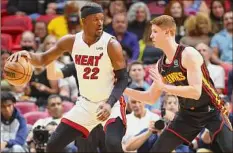  ?? Michael Reaves / Getty Images ?? Jimmy Butler of the Heat and Shenendeho­wa grad Kevin Huerter of the Hawks will meet in the playoffs’ first round.