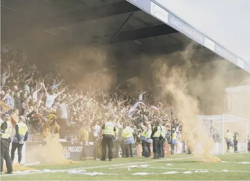  ?? ?? 0 Dundee United fans threw smoke bombs on to the pitch during their side’s 2-1 win over Ross County at the Global Energy Stadium