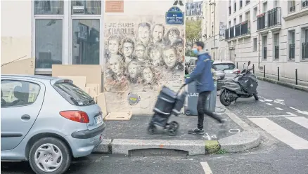  ??  ?? A makeshift mural on a wall with portraits of the ‘Charlie Hebdo’ magazine victims of a terrorist attack in Paris on Dec 14.