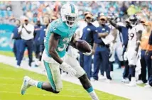  ?? LYNNE SLADKY/AP ?? Miami Dolphins running back Kenyan Drake had 120 yards and a touchdown on 23 carries, and 21 yards on three receptions against Denver.