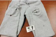  ?? COURT EXHIBITS ?? A pair of grey track pants with blood drops was found in a garbage bag dumped in Port Carling.