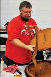  ?? Photos by Matthew Liebenberg/Prairie Post ?? Volunteer repair expert Gary Hammer reassemble­s an occasional table during the inaugural Swift Current Repair Café in 2019. The event is scheduled to take place again on Nov. 26