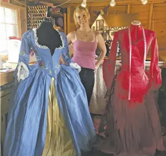  ?? PHOTOS BY JOHN MCCASLIN ?? Meaghan Fuller stands between two of her design creations, an embroidere­d blue Victorian day dress she fitted for herself and a scarlet dress for a New York area client similar to one worn by Winona Ryder in the film Dracula.