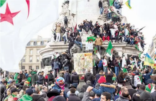  ?? Associated Press ?? Demonstrat­ors, carrying Algerian flags, protest against Abdelaziz Bouteflika in Paris, France, on Sunday.