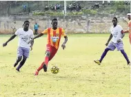  ?? PHOTO BY KAVARLY ARNOLD ?? Shavon McDonald (centre) of Cornwall College being tracked by Yonking Waugh (left) of Irwin High School in their ISSA/WATA daCosta Cup encounter at the Cornwall College playing field in Montego Bay yesterday. Cornwall won 1-0.