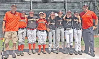  ?? TIMES COLONIST ?? Beacon Hill majors coach Craig Shaw, left, and manager Tak Niketas, right, flank some of their players who will compete for the B.C. title at their home park.