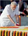  ?? PTI ?? Narendra Modi pays floral tributes to Mahatma Gandhi at Rajghat in New Delhi on Monday. —