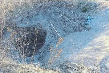  ?? ?? LARGE PIT: A hole dug out by illegal sand miners