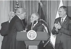  ?? PABLO MARTINEZ MONSIVAIS, AP ?? President Trump greets Environmen­tal Protection Agency Administra­tor Scott Pruitt before signing the order Tuesday.