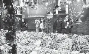  ?? — Gambar AFP ?? Para pembeli membeli manisan di kedai Manchester Christmas Market di Manchester, utara England.