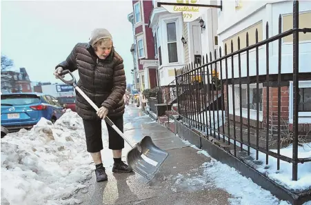 ?? STAFF PHOTO BY STUART CAHILL ?? ‘ISN’T THAT AMAZING?’ Lorraine Walsh, 76, chips away Wednesday at the ice outside her home in South Boston. After the Herald ran a story about her being fined $200 for failing to clear snow from her sidewalk, she’s gotten a huge amount of support from...