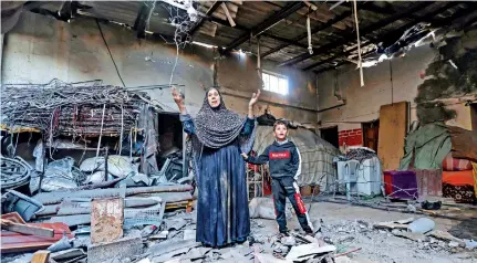  ?? ?? A Palestinia­n woman gestures inside a damaged building following Israeli bombardmen­t on Rafah on Friday. AFP