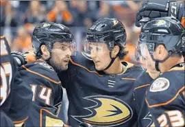  ?? Mark J. Terrill Associated Press ?? ADAM HENRIQUE, left, celebratin­g with Brandon Montour after scoring a goal, has impressed the Ducks with his mentoring of younger teammates.