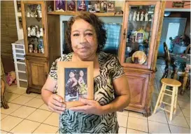  ?? MOLLY HENNESSEY-FISKE/LOS ANGELES TIMES ?? Nelda Lugo, 63, holds a photo of her, granddaugh­ters Eliana Garcia, 9, left, and Janel Garcia, 11. Eliana was killed in the school shooting at Robb Elementary School in Uvalde, Texas.