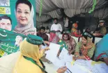  ??  ?? Workers of the PMLN political party guide voters outside a polling station in Lahore, Pakistan, Sept. 17.