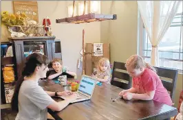  ?? PHOTOS SUBMITTED ?? McDonald County High School biology teacher Joelle Stark works from home, along with children Logan Stark (left), Claire Stark and Kelcey Martinez.