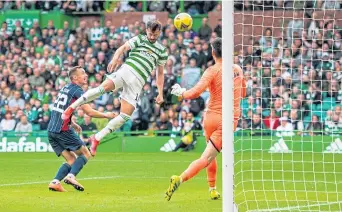  ??  ?? Albian Ajeti rises to head home the first of his two goals to make it 2-0 Celtic