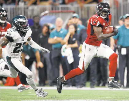  ?? JOHN BAZEMORE/AP ?? Atlanta Falcons receiver Julio Jones runs toward the end zone for a fourth-quarter touchdown as Eagles free safety Rodney McLeod pursues.