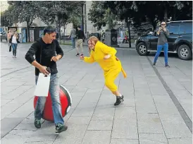  ?? Picture: GETTY IMAGES ?? HEALTHIEST APP: Young Kiev residents in Pokémon costumes hunt passers-by in the same way that people hunt Pokémon playing the game with their smartphone­s