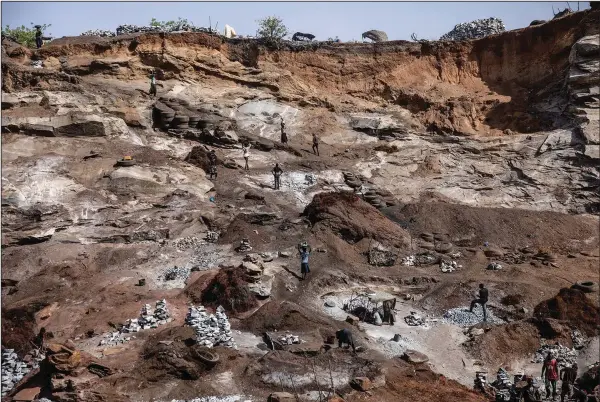  ?? (AP/Sophie Garcia) ?? People work April 27 in a granite mine on the outskirts of Ouagadougo­u, Burkina Faso.