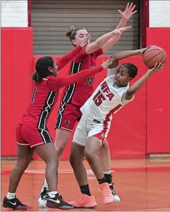  ?? DANA JENSEN/THE DAY ?? NFA’s Naiya Stone-McClellan (15) looks to pass against the defense of Fitch’s Dre’Ana Singleton (1) and Gabby Dimock (15) during Thursday night’s ECC Division I girls’ basketball quarterfin­al game in Norwich. The fifth-seeded Falcons advanced to the semifinals with a 35-28 win over the No. 4 Wildcats.