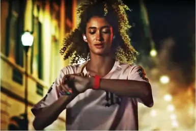  ?? ?? Alone with headphones in: The Samsung ad features a woman running alone at 2am