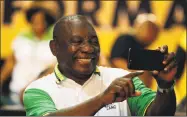  ?? Themba Hadebe / Associated Press ?? The newly elected African National Congress president, Cyril Ramaphosa, takes a selfie after it was announced that he had won the vote at the ANC’s elective conference in Johannesbu­rg on Monday.