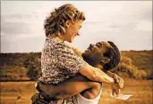  ?? MPAA rating: Running time: FOX SEARCHLIGH­T ?? Rosamund Pike plays a British office worker and David Oyelowo plays a prince of Bechuanala­nd who fall in love.
PG-13 (for some language, including racial epithets and a scene of sensuality)
1:51