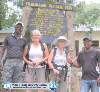  ??  ?? June McGahey (left) and Helene Lambrechts with their guides before their Mount Kilimanjar­o climb.