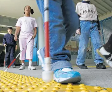  ?? Don Bartletti Los Angeles Times ?? “BUMPY TILE” helps blind students at Frances Blend Elementary learn to navigate. It’s uncertain whether disabled children will fare better under newly changed operating rules for charters in L.A. Unified.