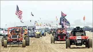 ?? DAVID MIDDLECAMP / THE TRIBUNE (OF SAN LUIS OBISPO) VIA AP ?? In this 2018 photo, hundreds of dune buggies parade along the Oceano Dunes State Recreation­al Vehicle Area, the line stretching south to north in Oceano, Calif. The California Coastal Commission has voted to end off-highway vehicle use at Oceano Dunes State Vehicular Recreation Area within three years, a decision that follows years of debate over environmen­tal and cultural impacts.