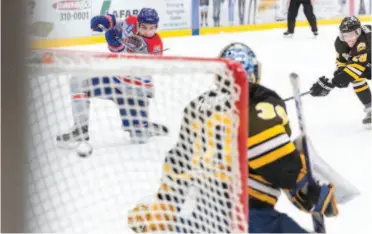  ?? CITIZEN PHOTO BY JAMES DOYLE ?? Prince George Spruce Kings forward Ben Poisson scores on a one-timer against the Coquitlam Express on Saturday night at Rolling Mix Concrete Arena.