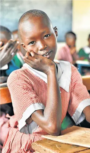  ??  ?? WILDEST DREAMS: A young pupil at work in the local school, which is supported by conservanc­y lodges