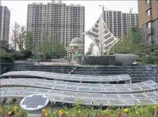 ?? Photos by Calum Macleod, USA TODAY ?? Energy-saving design: Solar panels evoking a dragon in flight greet visitors to Utopia Garden, an eco-friendly apartment complex in Dezhou, China, that uses coal-fired electricit­y for more than 90% of its power needs.