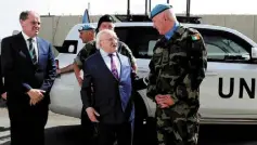  ??  ?? MISSION OVER: President Michael D Higgins and Minister for Defence Paul Kehoe prepare to be flown out by helicopter