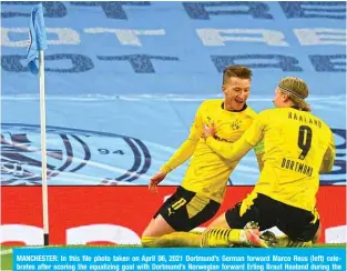  ?? — AFP ?? MANCHESTER: In this file photo taken on April 06, 2021 Dortmund’s German forward Marco Reus (left) celebrates after scoring the equalizing goal with Dortmund’s Norwegian forward Erling Braut Haaland during the UEFA Champions League first leg quarter-final football match between Manchester City and Borussia Dortmund at the Etihad Stadium in Manchester, north west England.