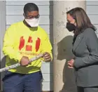  ?? MARK HOFFMAN/MILWAUKEE JOURNAL SENTINEL ?? Vice President Kamala Harris examines a lead pipe held by master plumber Reshawn Spivey on Monday.