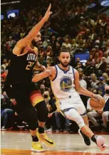  ?? Alex Goodlett / Getty Images ?? Warriors guard Stephen Curry drives against Utah’s Rudy Gobert during the second half Saturday night. Curry went 3-for-4 over the final 12 minutes to reach a game-high 28 points.