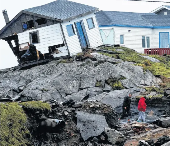  ?? REUTERS ?? Persons head to their homes in the aftermath of Hurricane Fiona in Burnt Islands, N.L, Sept. 27, 2022.