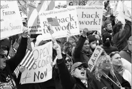  ?? ASSOCIATED PRESS ?? IN THIS APRIL 24 FILE PHOTO protesters gather for a rally against Gov. Tony Evers’ extended stay-at-home order due to COVID-19, at the Wisconsin State Capitol in Madison, Wis.