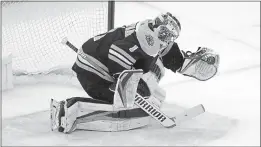  ?? CHARLES KRUPA — THE ASSOCIATED PRESS ?? Bruins goaltender Jeremy Swayman makes a glove save on a shot by Buffalo Sabres right wing Tage Thompson during the shootout on Tuesday in Boston. The Bruins won 3-2.