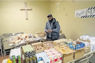  ?? Jim Mone, The Associated Press ?? Bishop Divar L. Bryant Kemp stands at the New Mount Calvary Baptist Church food shelf Oct. 1 in North Minneapoli­s. In addition to the food shelf, Kemp makes a plea year- round to his congregant­s and others outside of his church to get out and vote.